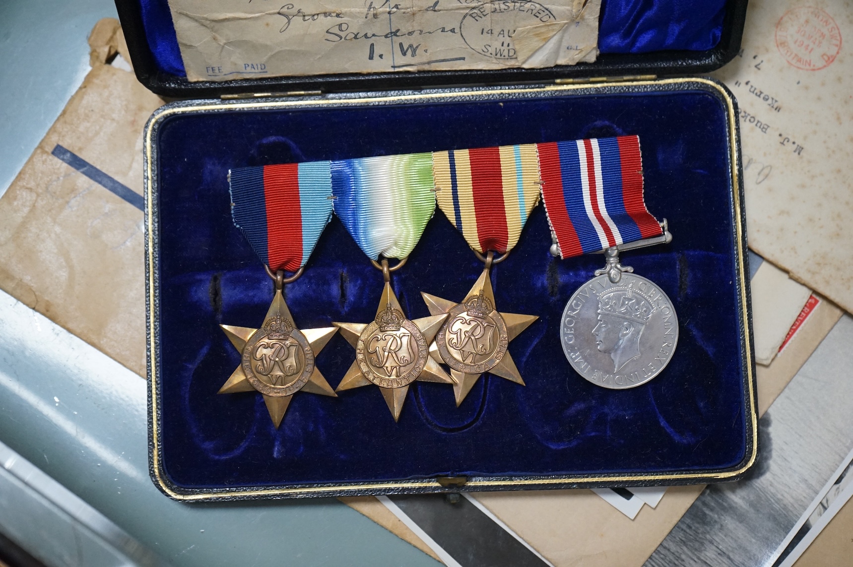 H.M.S. Hood related interest; a WWII medal group awarded to Midshipman P.J. Buckett R.N.V.R, comprising; the Atlantic Star, the Africa Star, the 1939-1945 Star and the 1939-1945 Medal, engraved with his name to the rear